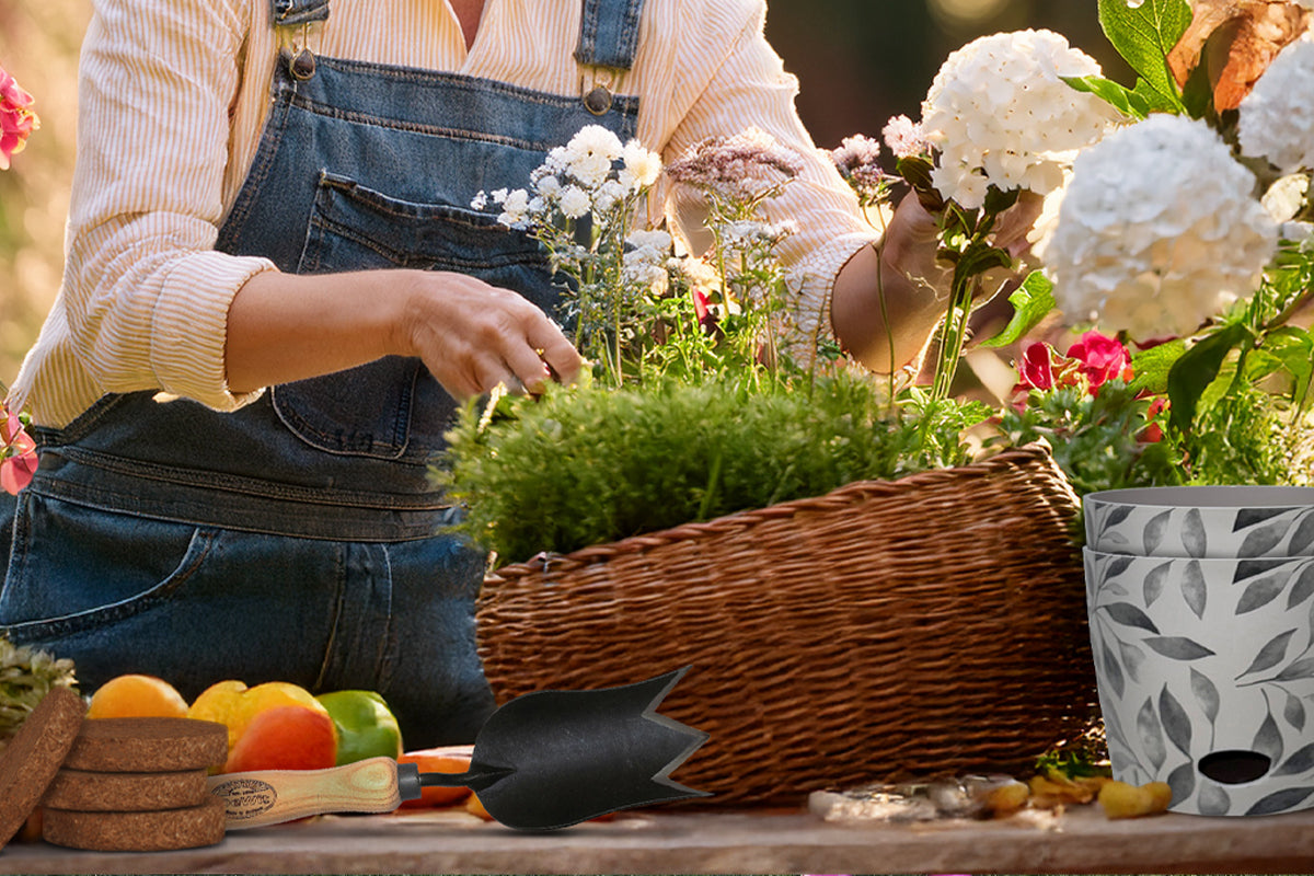 Mother's Day Gift Guide blog hero image featuring a woman using coir discs and a tulip trowel to harvest flowers from her garden to plant in a pot