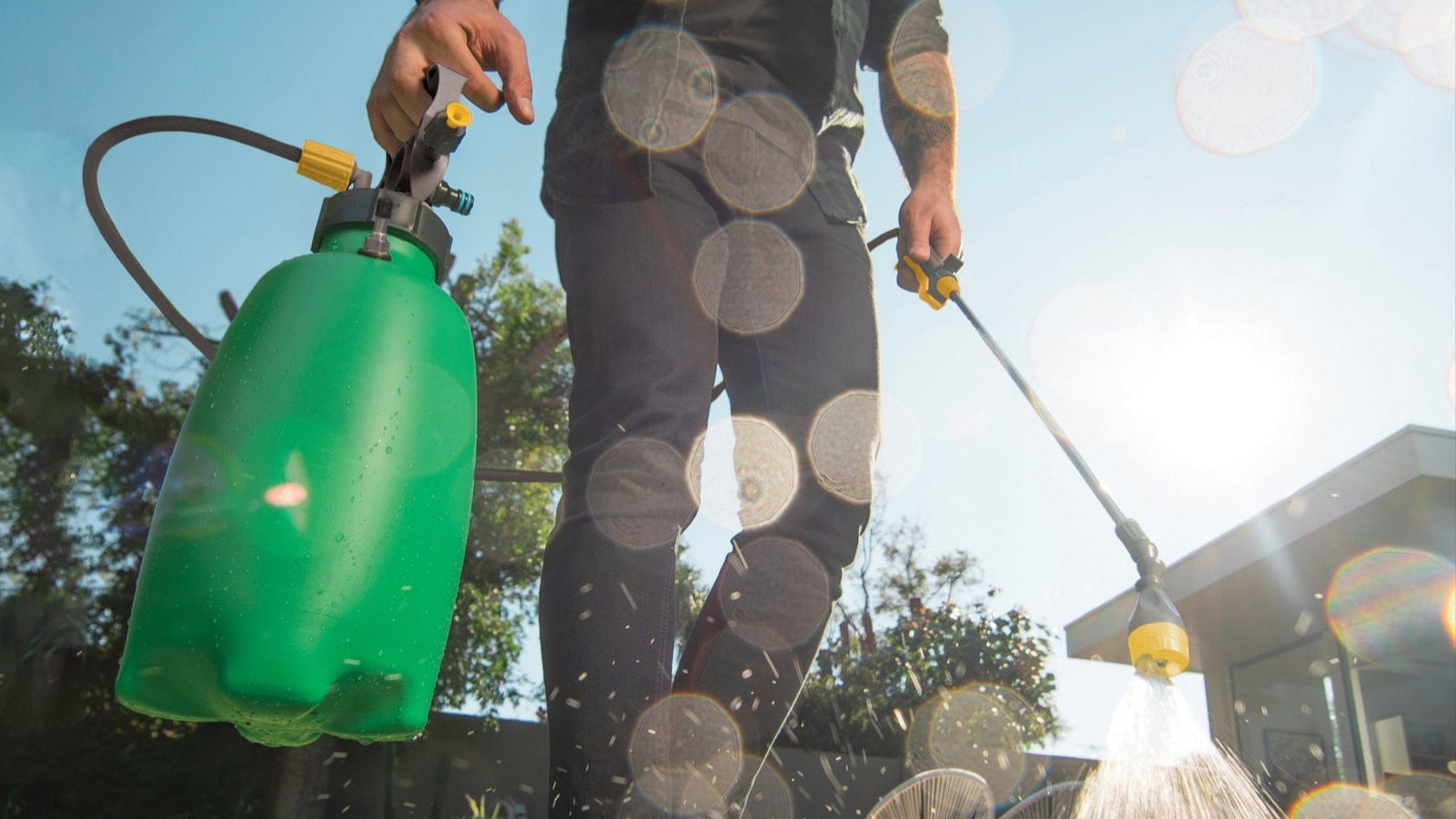 1.3 Gal Aussie Ezy Spray handheld sprayer in use on grass, featuring ergonomic handle and spray wand.
