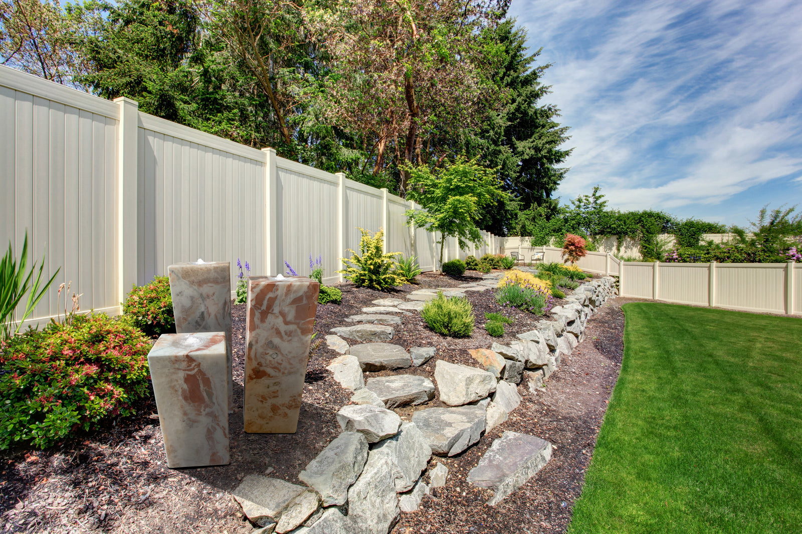 Cubed Red Onyx column trio enhances landscaping with vibrant stone columns.
