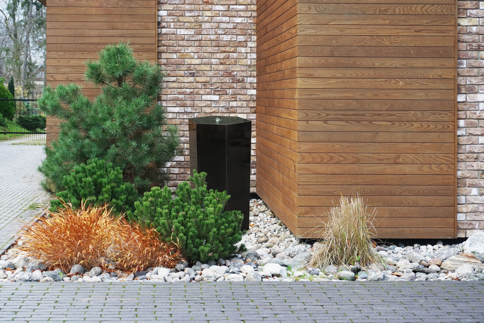 36" fully polished basalt column with hexagonal shape in modern landscape.