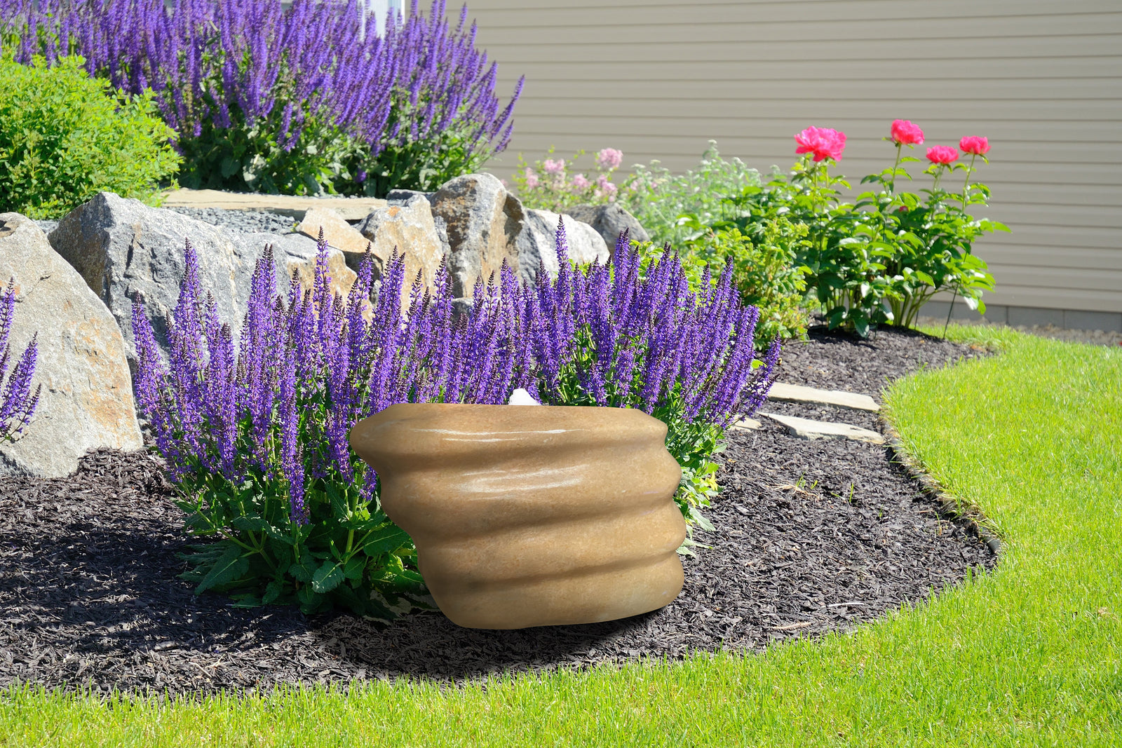 Polished ripple pink marble stone in garden setting for riverbed water features.