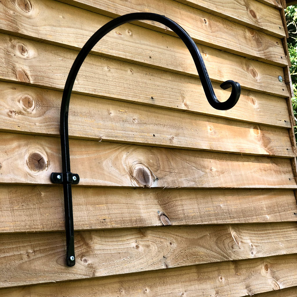 Multipurpose outdoor metal wall hook mounted on wooden wall, 3"W x 11"D x 11"H, ideal for garden decor.